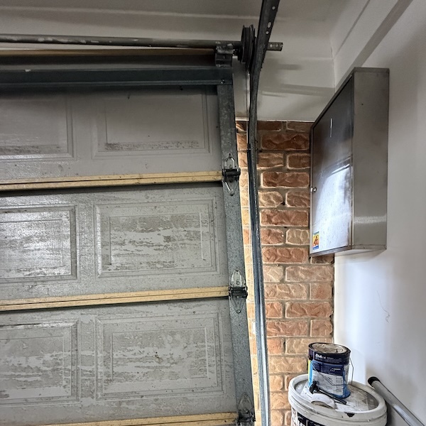 Replaced broken cable straight door put it back in the tracks after cables broke