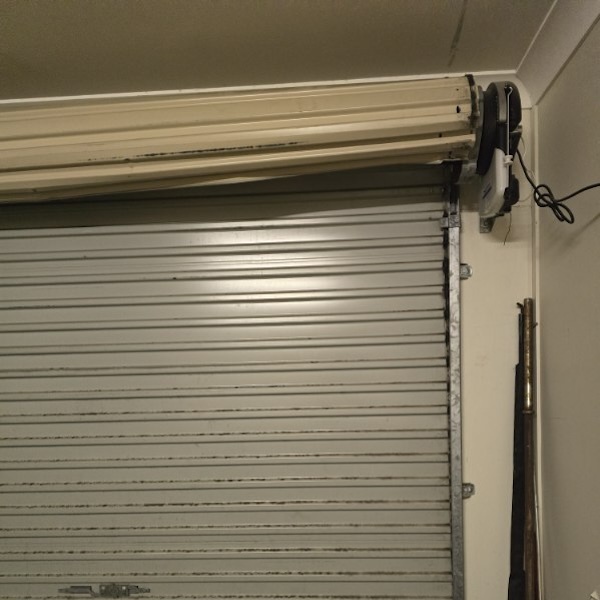 Roller door fell apart, put back together in service to run properly